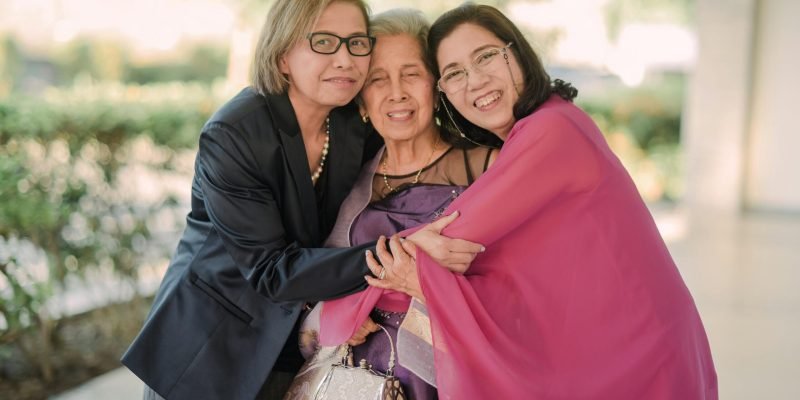 pexels-photo-19524029-19524029 Three women embracing, showcasing family love in Manila. Outdoor setting, smiling faces.
